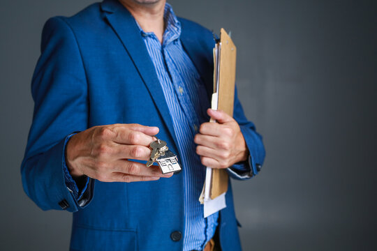 New Home Owner get the Key of his new Home from the real estate agent