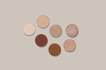 Pattern with eye shadow beige brown natural color on neutral colored background. Makeup palette,...