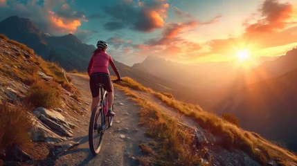 Tuinposter Woman riding bicycle at mountain during sunset © Eman Suardi