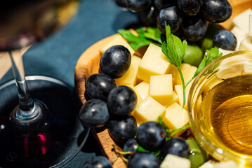 cheese, grapes and wine on table