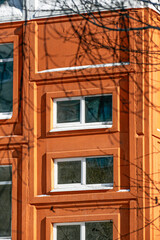 A fragment of the facade of a brick building on a winter day