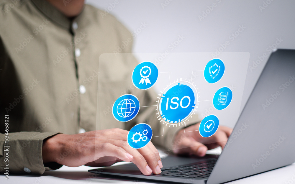 Poster iso standards quality control. person using laptop with iso icon on virtual screen for quality assur