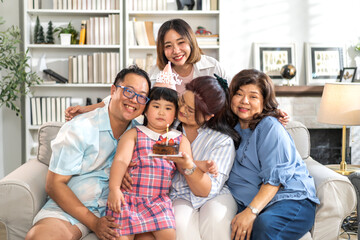Portrait of happy love asian big family father and mother with asian baby and little girl happy birthday, party, celebration, cake, surprise, grandmother smiling together.Family party