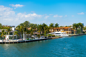 Fototapeta na wymiar Luxury summer villa with yacht pier. Vacation in summer paradise. Luxury resort at summertime. Travel to tropical bay of Florida. Summer vacation in tropical paradise resort. Fort Lauderdale