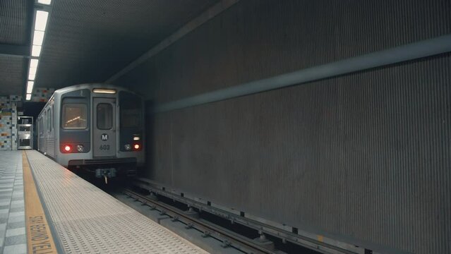 Train leaving metro station. American subway in California. Moving train underground. Departing from metro station. Train leaving Hollywood Western. Moving subway in Los Angeles. Traveling by subway.