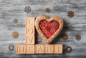 Love Heart letters with Steampunk Gears on texture wooden background