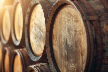 Fotobehang Close-up shot of stacked vintage wine barrels at the vineyard. © tonstock
