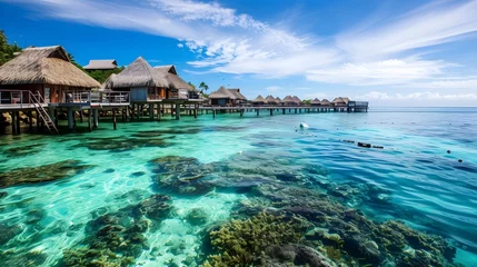 Fototapeten Exotic beach hut village with overwater bungalows and coral reefs  © PSCL RDL