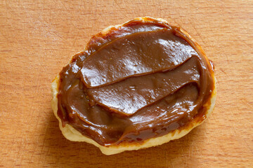 Pancakes with boiled condensed milk on a wooden surface. Close-up. Top view.
