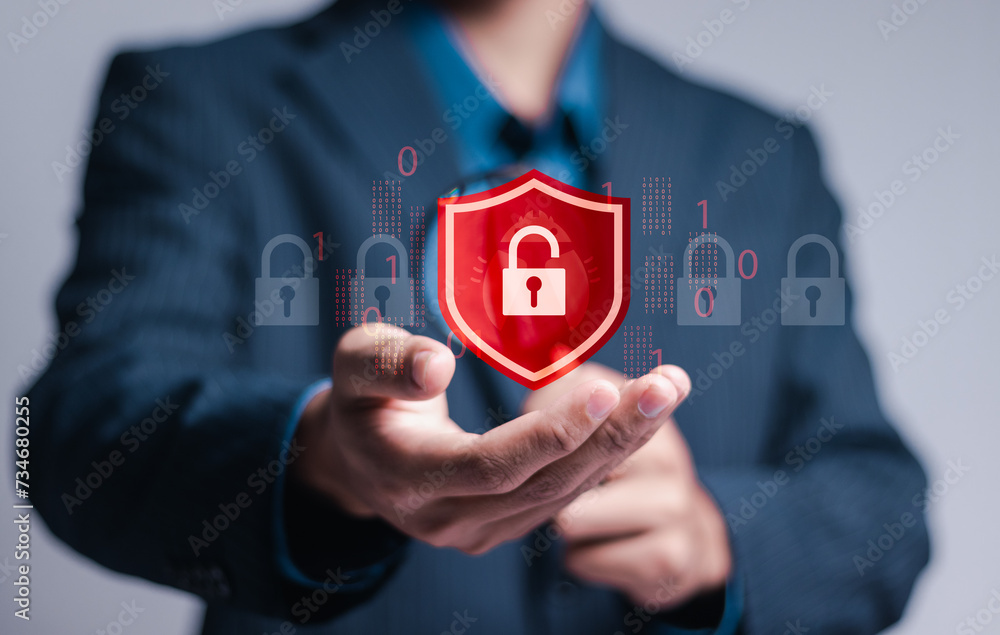 Poster hacker attack and data breach, information leak concept. businessman hold virtual red protection shi