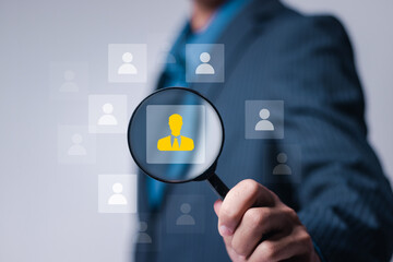 Human Resources management concept. HR manager use magnifying glass focus to HR icons for...