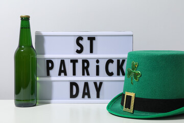 Green bottle, hat and light box with text on white background