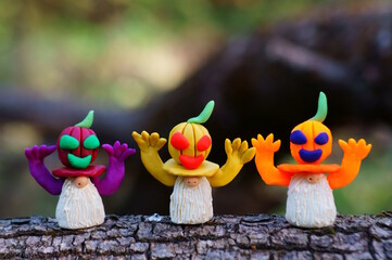 Figures of dwarfs decorated with pumpkin. Halloween decorations.