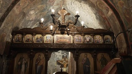 Greek orthodox church interior shot shows the church dome and chapel with beautiful hagiography