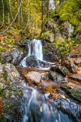 Landscape in autumn at Feldberg in the Black Forest. Hiking trail with a waterfall on the...
