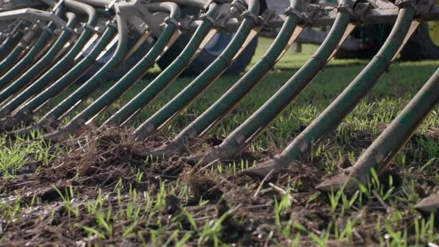 Liquid manure spreader releasing slurry on field close up slow motion