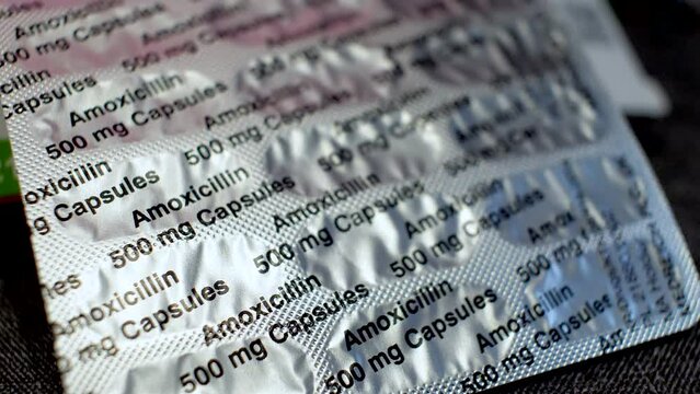 Amoxicillin capsules, oral antibiotic penicillin medicinal drug in silver foil protection