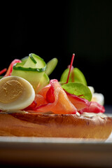 Toast with salmon and vegetables in a plate