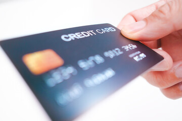 Credit card in a hand on white background , Credit card and financial concept