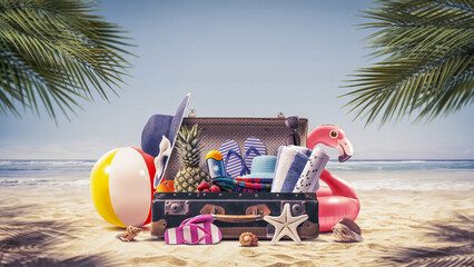 Suitcase with summer accessories at the beach