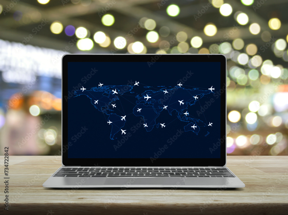Poster flight routes airplanes connection and world map on laptop computer screen on table over shopping ma