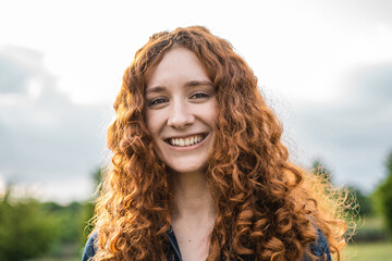Outdoor portrait of a ginger red haired woman