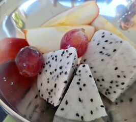 Fresh fruit is in the stainless steel cup.