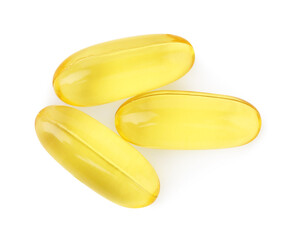 Many yellow vitamin capsules isolated on white, top view
