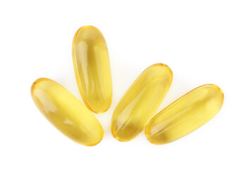 Many yellow vitamin capsules isolated on white, top view