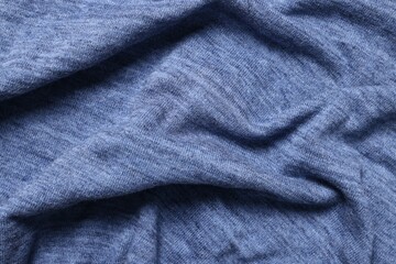 Texture of blue crumpled fabric as background, top view