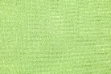 Texture of light green fabric as background, top view