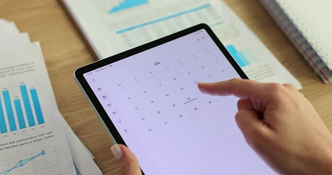 Businesswoman searching calendar for free day in schedule