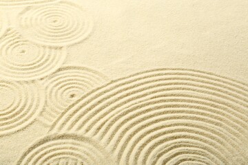 Fototapeta na wymiar Zen rock garden. Circle patterns on beige sand