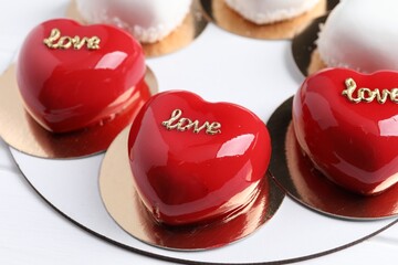 St. Valentine's Day. Delicious heart shaped cakes on white wooden table, closeup