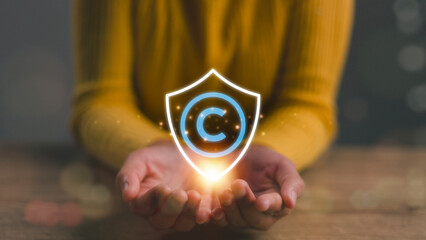 Copyright or patent concept, Women hand holding copyright icon with shield, Copyleft trademark...