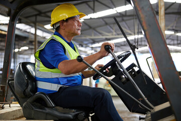 senior worker driving forklift in the factory