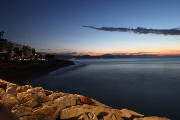 View from Torremolinos towards Malaga just before sunrise. Costa del Sol, Spain. - obrazy, fototapety, plakaty