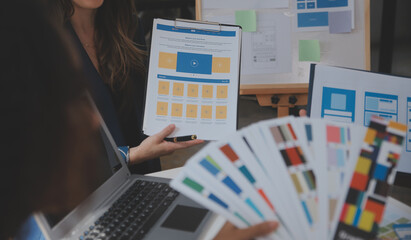 Close up ux developer and ui designer use augmented reality brainstorming about mobile app interface wireframe design on desk at modern office.Creative digital development agency