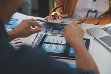 Close up ux developer and ui designer use augmented reality brainstorming about mobile app interface wireframe design on desk at modern office.Creative digital development agency