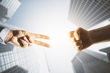 Close up of young business men hands playing rock paper scissors on bright light city buildings...