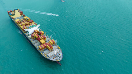 side view Cargo Container ship with contrail in the ocean ship carrying container and running for...