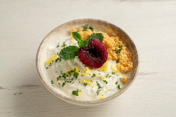 Yogurt and lemon mousse with cherries.