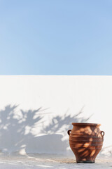 Amphora in front of a white wall in Serifos, Cyclades, Greece