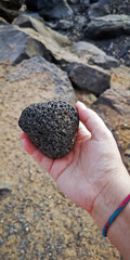 piece of raw pumice stone, held in the palm