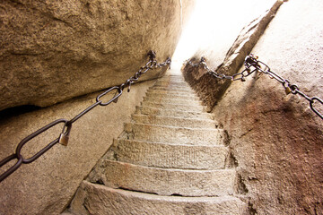 Hua Shan mountains in China. High stone stairs. Hiking up the mountain. Steep stairs. Dangerous...