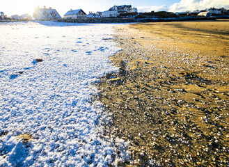 Shoreline on a sunny day covered with a layer of salt