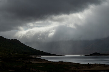 Breathtaking landscape showcasing majestic mountains and sea against the cloudy sky