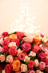 Beautiful bouquet of colorful roses on beige background