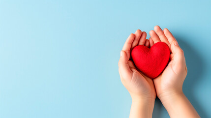 Woman's hands holding red heart on grey background. Valentine's day, health care, world heart day, world health day.