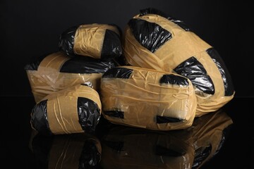 Smuggling and drug trafficking. Packages with narcotics on black mirror surface